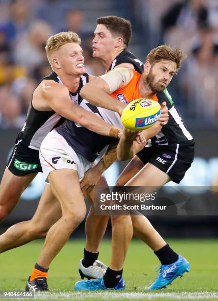 Callan Ward of the Giants is tackled during the round two AFL match between the Collingwood Magpies and the Greater Western Sydney Giants at...