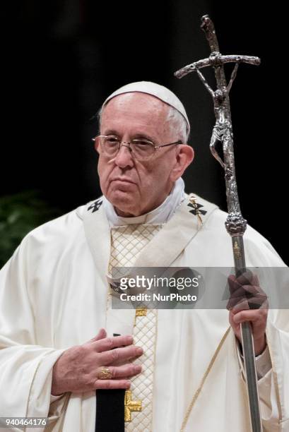 Pope Francis presides over a solemn Easter vigil ceremony in St. Peter's Basilica at the Vatican, Saturday, March 31, 2018.