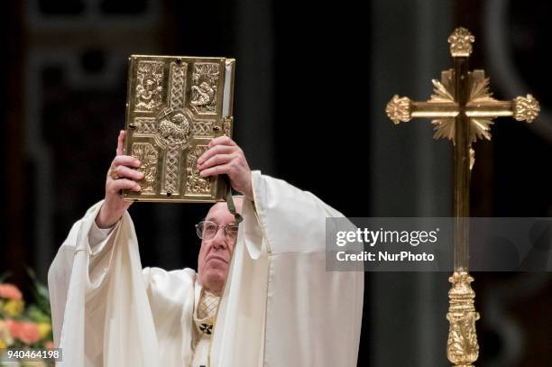 Pope Francis holds Holy Bible during he has presides over a solemn Easter vigil ceremony in St. Peter's Basilica at the Vatican, Saturday, March 31,...