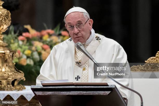 Pope Francis presides over a solemn Easter vigil ceremony in St. Peter's Basilica at the Vatican, Saturday, March 31, 2018.