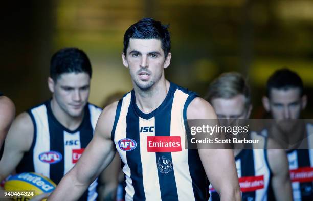 Scott Pendlebury of the Magpies leads his side onto the field during the round two AFL match between the Collingwood Magpies and the Greater Western...