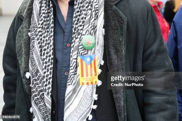 Man with Kuffiyah, a catan sticker and a button of the kurdish Women's Defense Unit . Some dozens of catalans and sympathisers rallied demanding...