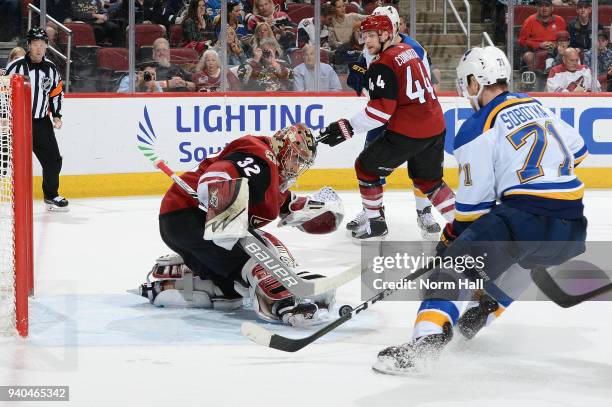 Goalie Antti Raanta of the Arizona Coyotes stops the puck as Vladimir Sobotka of the St Louis Blues skates in during the third period at Gila River...