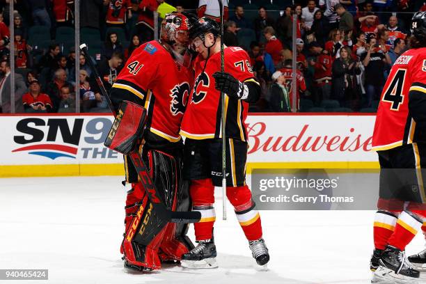 Mike Smith and Micheal Ferland of the Calgary Flames celebrate a win after an NHL game against the Edmonton Oilers on March 31, 2018 at the...