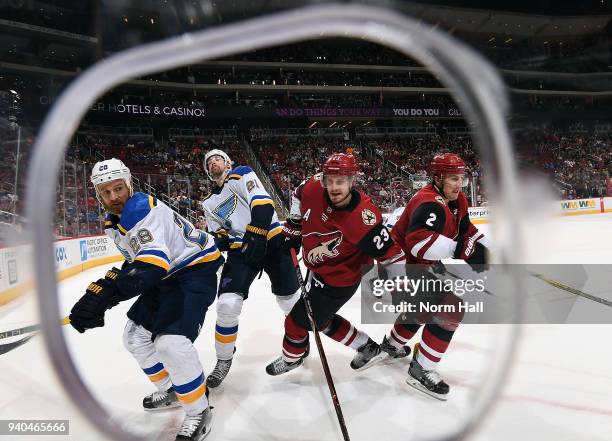 Kyle Brodziak and Patrik Berglund of the St Louis Blues battles with Oliver Ekman-Larsson and Luke Schenn of the Arizona Coyotes during the third...