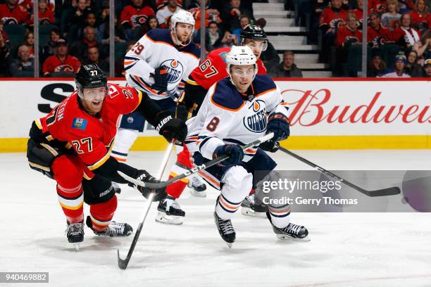 Dougie Hamilton of the Calgary Flames skates against Ty Rattie of the Edmonton Oilers during an NHL game on March 31, 2018 at the Scotiabank...