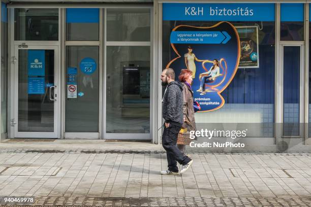 People walking in front of K&amp;H Bank belonging to KBC Bank are seen in Miskolc, Hungary on 31 March 2018