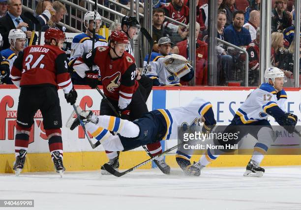 Zac Rinaldo and Dylan Strome of the Arizona Coyotes trip up Alexander Steen of the St Louis Blues during the second period at Gila River Arena on...