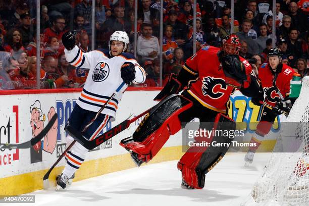 Mike Smith of the Calgary Flames skates against Pontus Aberg of the Edmonton Oilers during an NHL game on March 31, 2018 at the Scotiabank Saddledome...