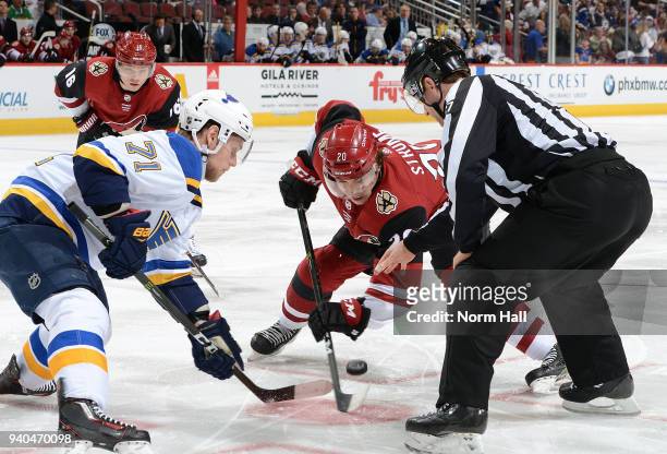 Dylan Strome of the Arizona Coyotes and Vladimir Sobotka of the St Louis Blues battle for a face-off during the second period at Gila River Arena on...