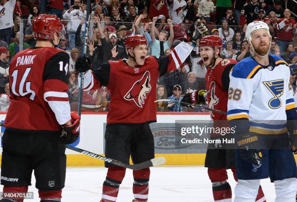 Jakob Chychrun and Oliver Ekman-Larsson of the Arizona Coyotes celebrate as teammates Richard Panik skates in following Ekman-Larsson's second period...