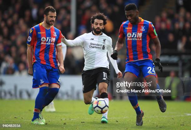 Mohamed Salah of Liverpool in action with Luka Milivojevic and Timothy Fosu-Mensah of Crystal Palace during the Premier League match between Crystal...