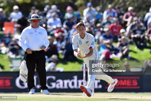 Trent Boult of New Zealand fields the ball off his own bowling during day three of the Second Test match between New Zealand and England at Hagley...