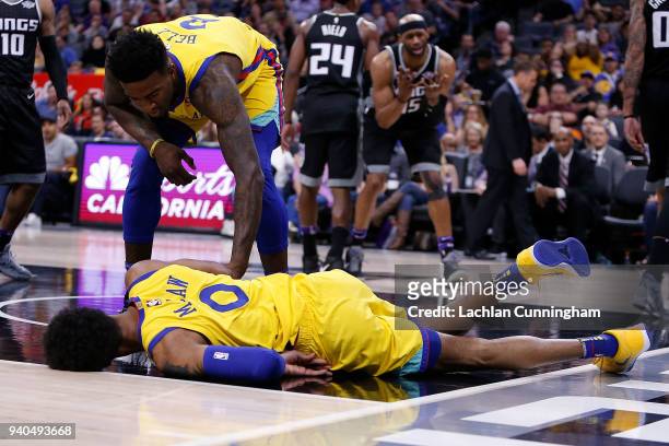 Patrick McCaw of the Golden State Warriors rolls on the floor injured after being fouled by Vince Carter of the Sacramento Kings at Golden 1 Center...