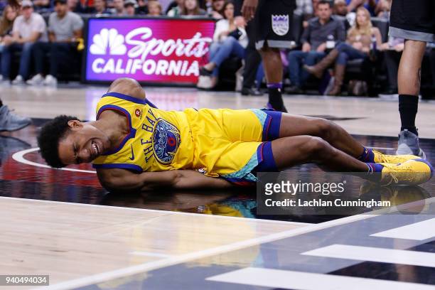Patrick McCaw of the Golden State Warriors lands heavily after being fouled by Vince Carter of the Sacramento Kings at Golden 1 Center on March 31,...