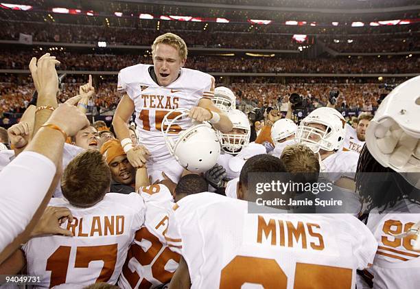 Hunter Lawrence of the Texas Longhorns celebrates with his team after kicking the game-winning field goal to win the game 10-6 over the Nebraska...