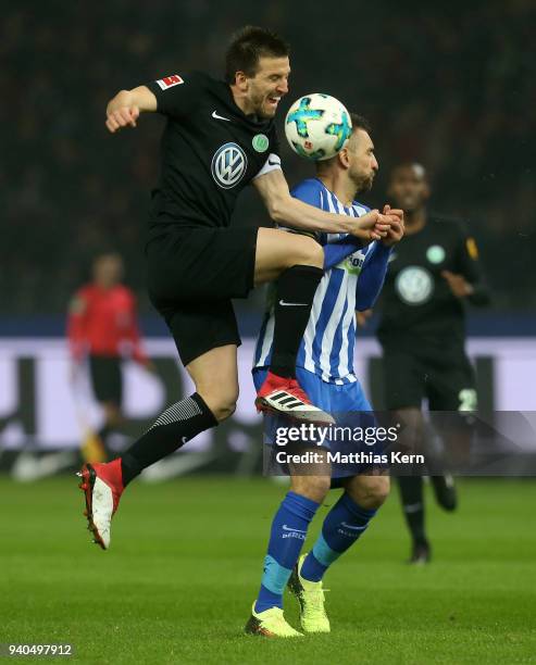 Vedad Ibisevic of Berlin battles for the ball with Ignacio Camacho of Wolfsburg during the Bundesliga match between Hertha BSC and VFL Wolfsburg at...