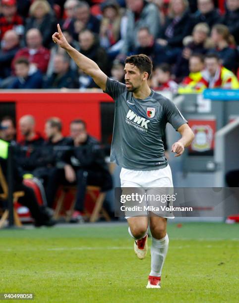 Rani Khedira of Augsburg reacts during the Bundesliga match between Bayer 04 Leverkusen and FC Augsburg at BayArena on March 31, 2018 in Leverkusen,...