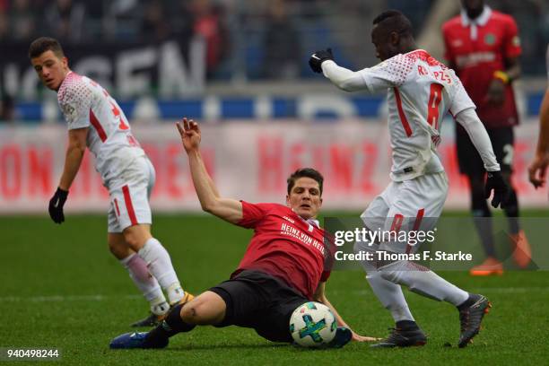 Pirmin Schwegler of Hannover tackles Naby Keita of Leipzig during the Bundesliga match between Hannover 96 and RB Leipzig at HDI-Arena on March 31,...