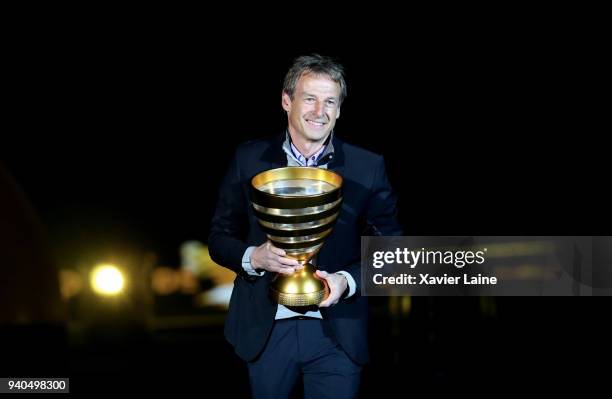 Jurgen Klinsmann present the cup before the League Cup Final match between Paris Saint-Germain and AS Monaco at Matmut Arena on March 31, 2018 in...