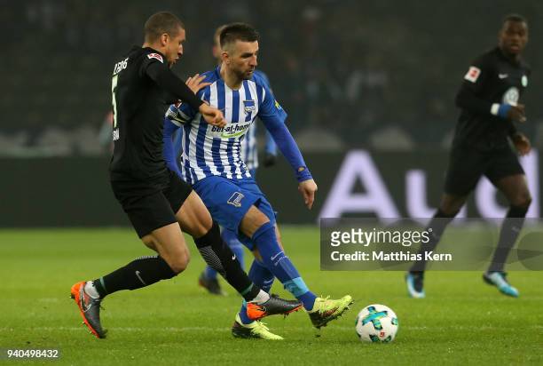 Vedad Ibisevic of Berlin battles for the ball with Jeffrey Bruma of Wolfsburg during the Bundesliga match between Hertha BSC and VFL Wolfsburg at...