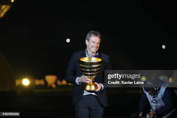 Jurgen Klinsmann present the cup before the League Cup Final match between Paris Saint-Germain and AS Monaco at Matmut Arena on March 31, 2018 in...