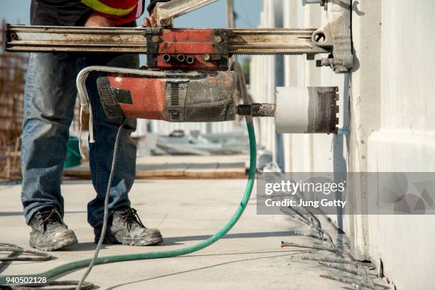construction worker coring concrete - trapano elettrico foto e immagini stock