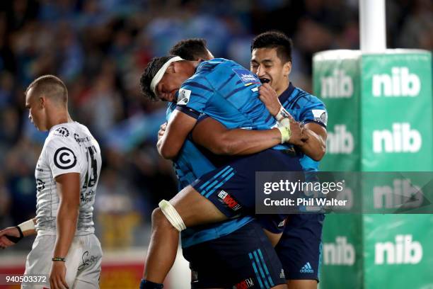 Murphy Taramai of the Blues congratulates Patrick Tuipulotu on his try during the round sevens Super Rugby match between the Blues and the Sharks at...