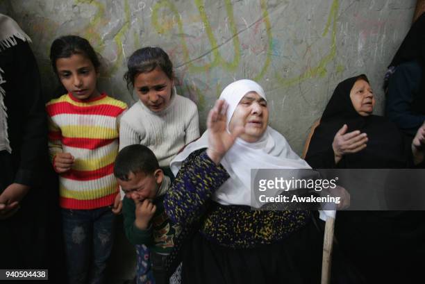 Relatives of Palestinian Ibrahim Abu Shaar, who was killed along Israel border with Gaza, mourn during his funeral in Rafah town, in the southern...