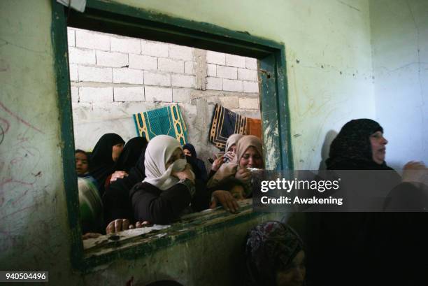 Relatives of Palestinian Ibrahim Abu Shaar, who was killed along Israel border with Gaza, mourn during his funeral in Rafah town, in the southern...