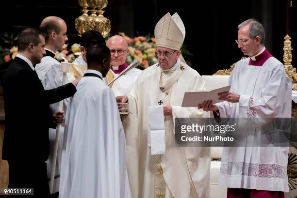 Pope Francis baptizes John Francesco Ogah, Nigerian migrant-hero, during a solemn Easter vigil ceremony in St. Peter's Basilica at the Vatican, 31...