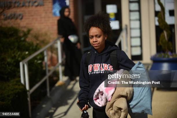 With their pillows and blankets, some Howard University students leave the administration building where they spent the night while continuing to...