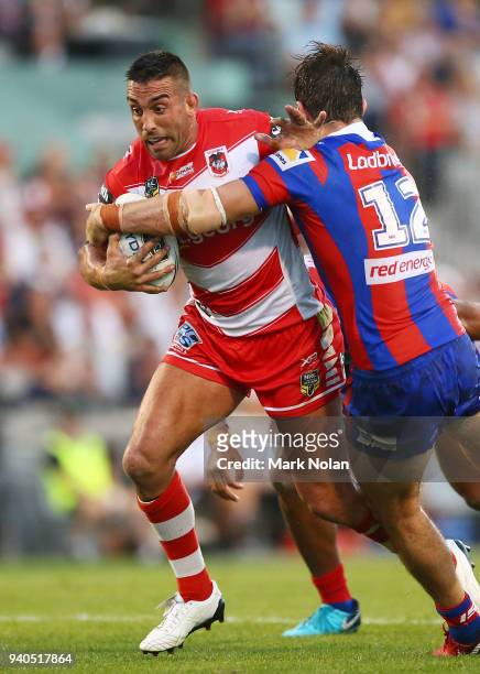 Paul Vaughan of the Dragons is tackled during the round four NRL match between the St George Illawarra Dragons and the Newcastle Knights at WIN...