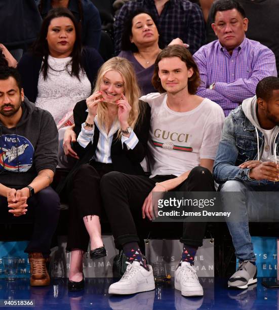 Dakota Fanning and Henry Frye attend New York Knicks vs Detroit Pistons game at Madison Square Garden on March 31, 2018 in New York City.