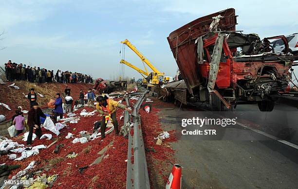 Chinese villagers gather to salvage what is left of the cargo on a truck carrying gunpowder to a fireworks factory, which exploded in Xiaogan, in...