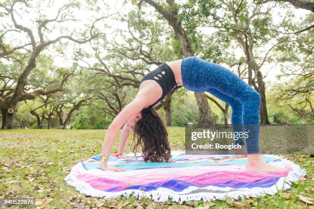 flexible woman in urdhva dhanurasana yoga backbend outdoors in miami - bending over backwards stock pictures, royalty-free photos & images
