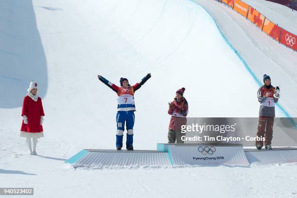 Marie Martinod of France celebrates on the podium after winning the silver medal watched by gold medalist Cassie Sharpe of Canada and bronze medalist...