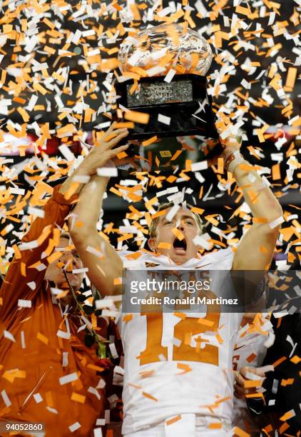 Quarterback Colt McCoy of the Texas Longhorns lifts the trophy with head coach Mack Brown after their teams 10-6 victory over the Nebraska...
