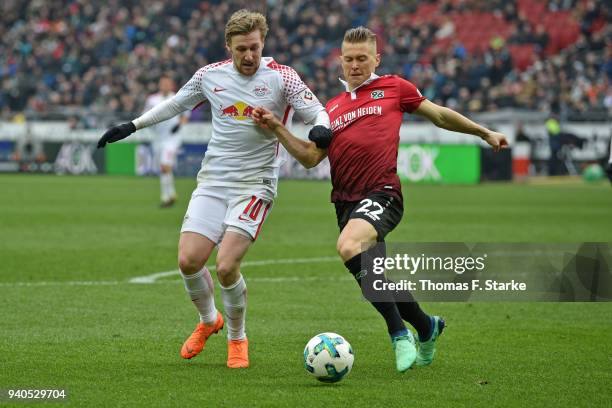 Emil Forsberg of Leipzig and Matthias Ostrzolek of Hannover fight for the ball during the Bundesliga match between Hannover 96 and RB Leipzig at...