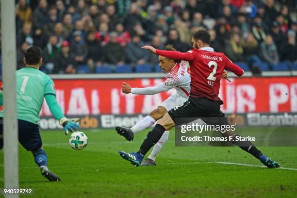 Yussuf Poulsen of Leipzig misses to score against Philipp Tschauner and Josip Elez of Hannover during the Bundesliga match between Hannover 96 and RB...