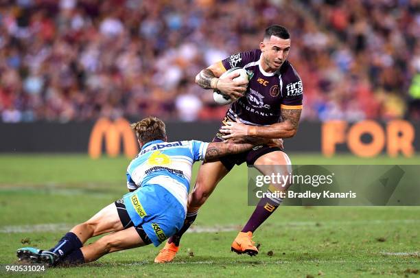 Darius Boyd of the Broncos takes on the defence during the round four NRL match between the Brisbane Broncos and the Gold Coast Titans at Suncorp...