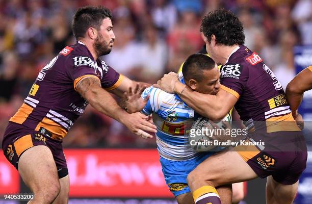 Phillip Sami of the Titans takes on the defence during the round four NRL match between the Brisbane Broncos and the Gold Coast Titans at Suncorp...