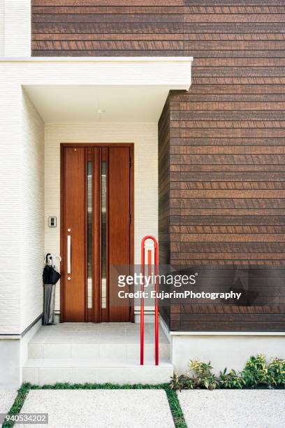 front door of modern design house with red mailbox and umbrella stand - modern building entrance stock pictures, royalty-free photos & images