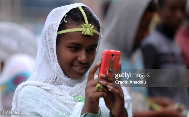 Ethiopian Orthodox Christians wearing leaf crowns made out of date palm, gather to attend the Hosanna Day celebrations ahead of the Easter, at the...