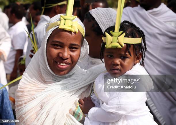 Ethiopian Orthodox Christians wearing leaf crowns made out of date palm, gather to attend the Hosanna Day celebrations ahead of the Easter, at the...