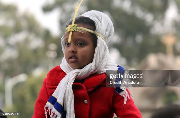 Ethiopian Orthodox Christians wearing leaf crowns made out of date palm, gather to attend the Hosanna Day celebrations ahead of the Easter, at the...