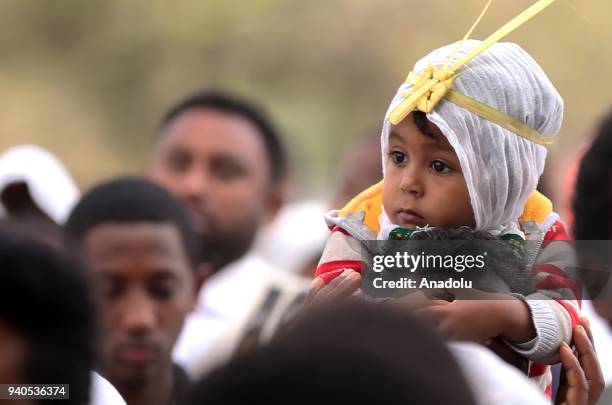 Ethiopian Orthodox Christians wearing leaf crowns made out of date palm, gather to attend the Hosanna Day celebrations ahead of the Easter, at the...