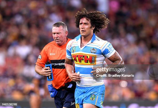 Kevin Proctor of the Titans is taken from the field with a head injury during the round four NRL match between the Brisbane Broncos and the Gold...