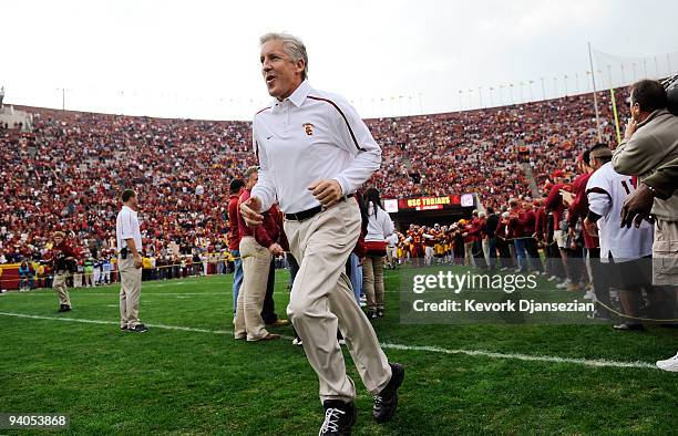 Coach Pete Carroll of the USC Trojans leads his team on to the field prior to the start of the NCAA college football game against Arizona Wildcats at...