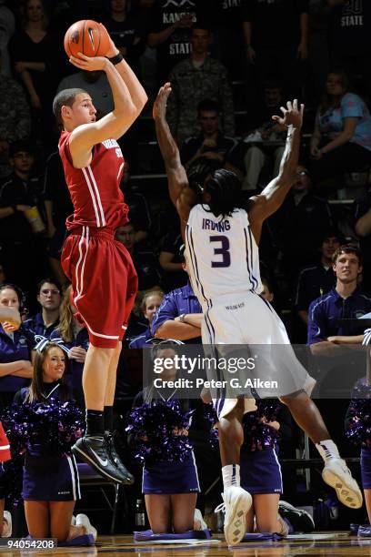 Guard Klay Thompson of the Washington State Cougars puts up a shot over pressure from guard Martavious Irving of the Kansas State Wildcats in the...